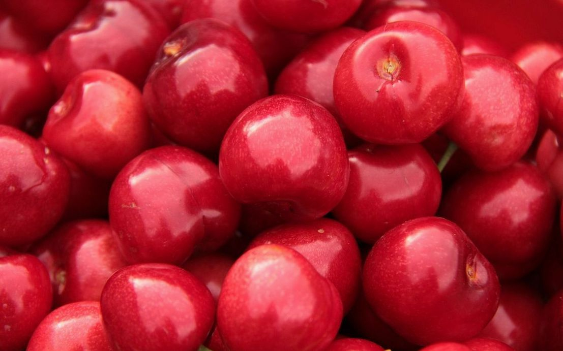 Fresh berries arranged in a wooden crate